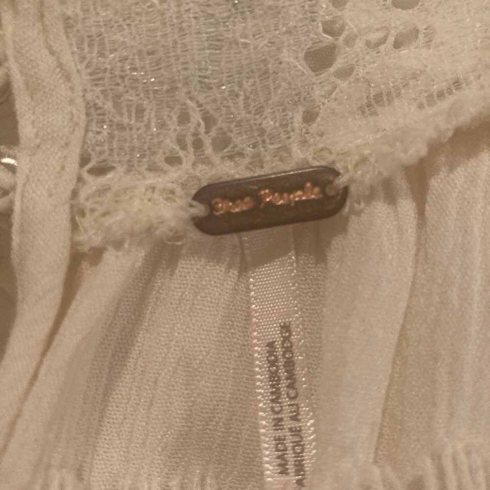 Gorgeous Free People light cream top with beautiful lace details on cuffs